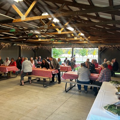 a group of people standing around a table